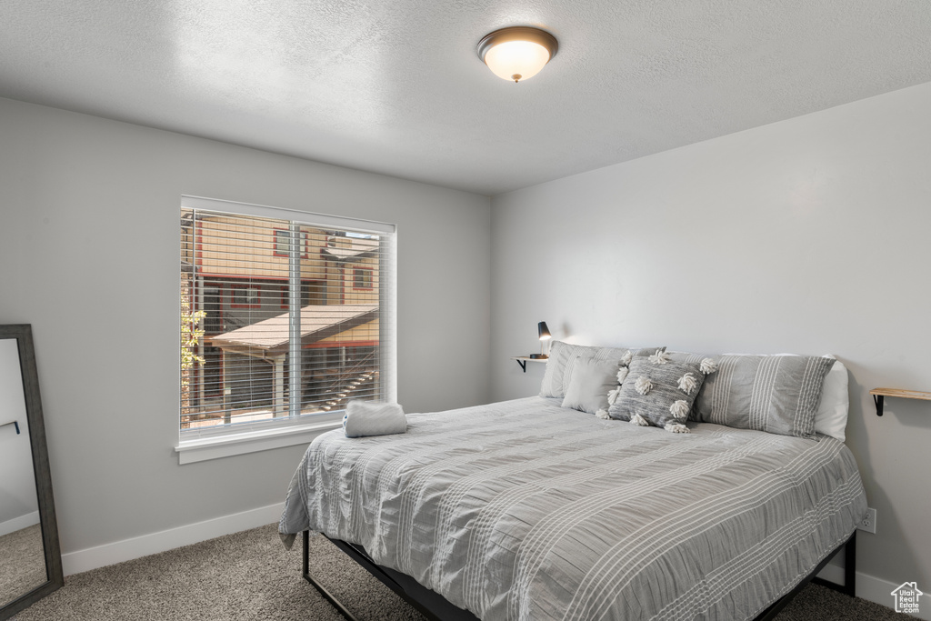 Bedroom with carpet and baseboards