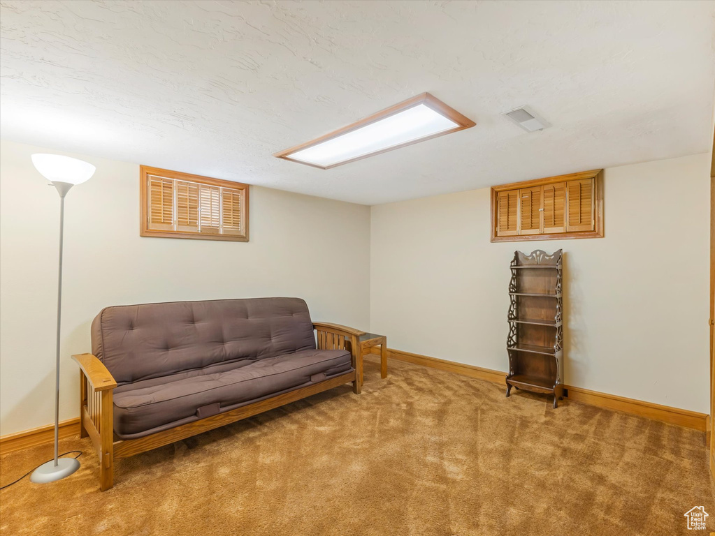 Living area with carpet flooring and baseboards