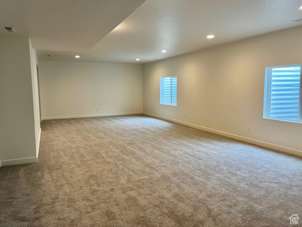 Carpeted empty room featuring recessed lighting