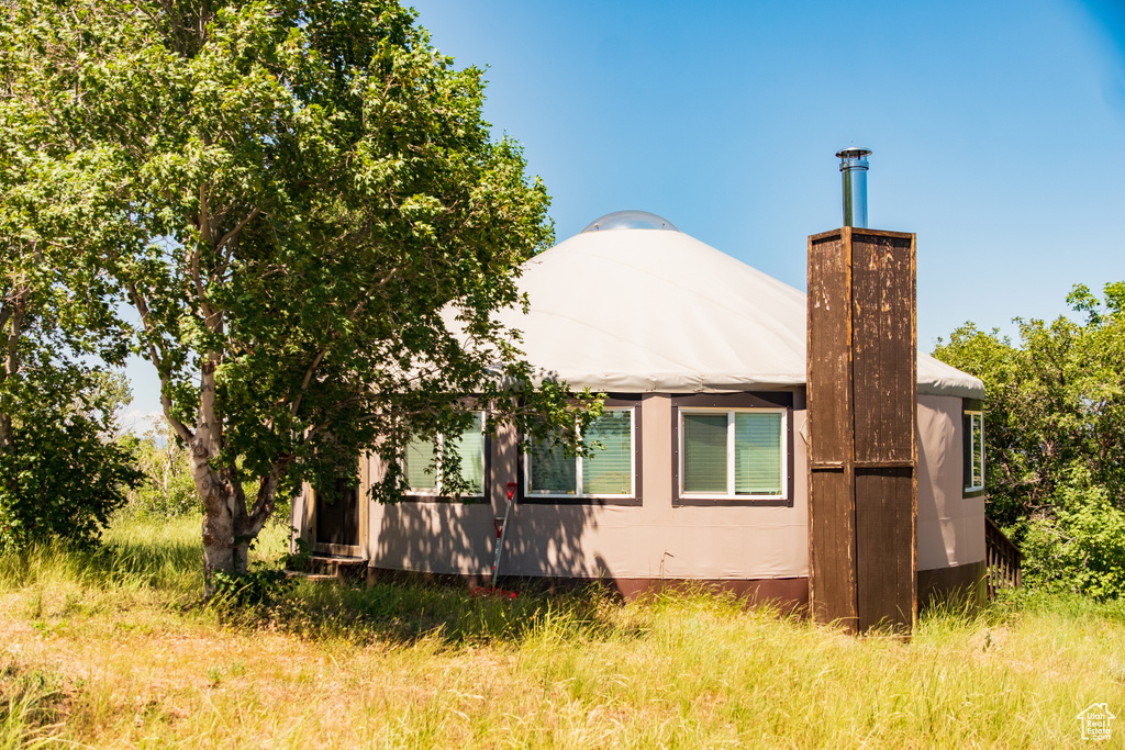 View of property exterior with a chimney