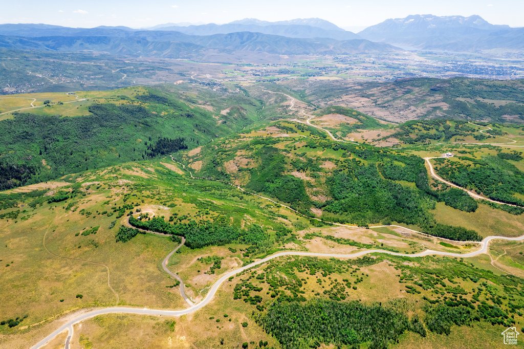 Aerial view of property and surrounding area featuring mountains