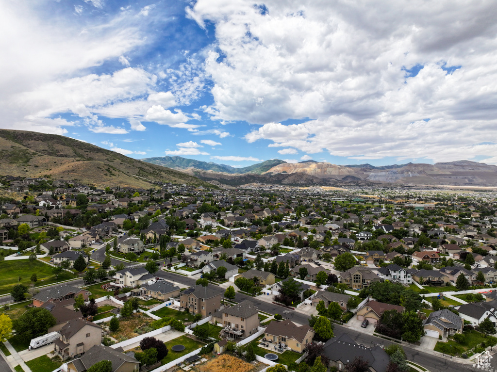 Aerial perspective of suburban area featuring a mountainous background