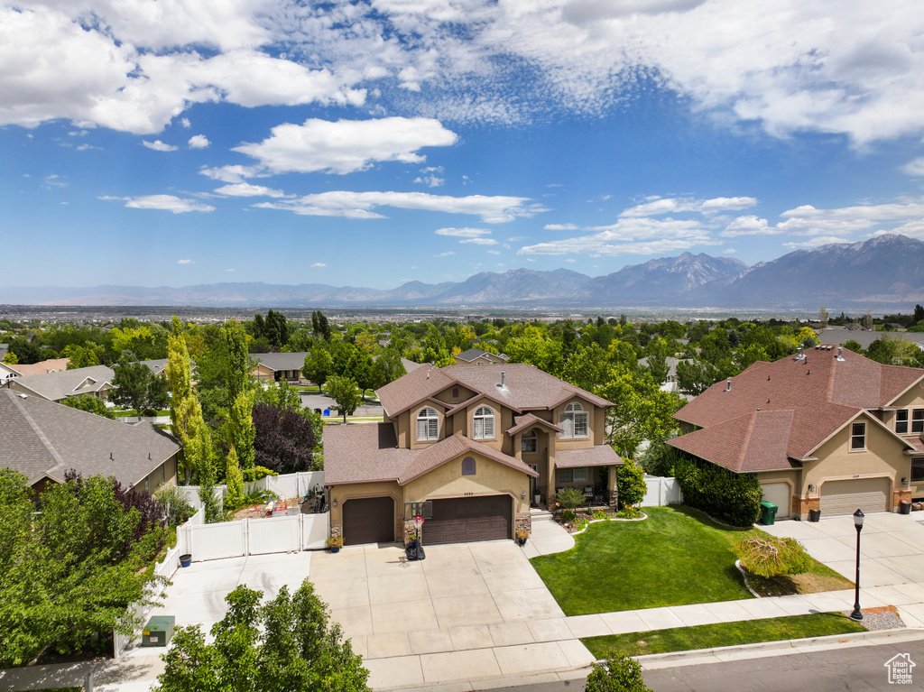 Aerial perspective of suburban area featuring a mountain backdrop