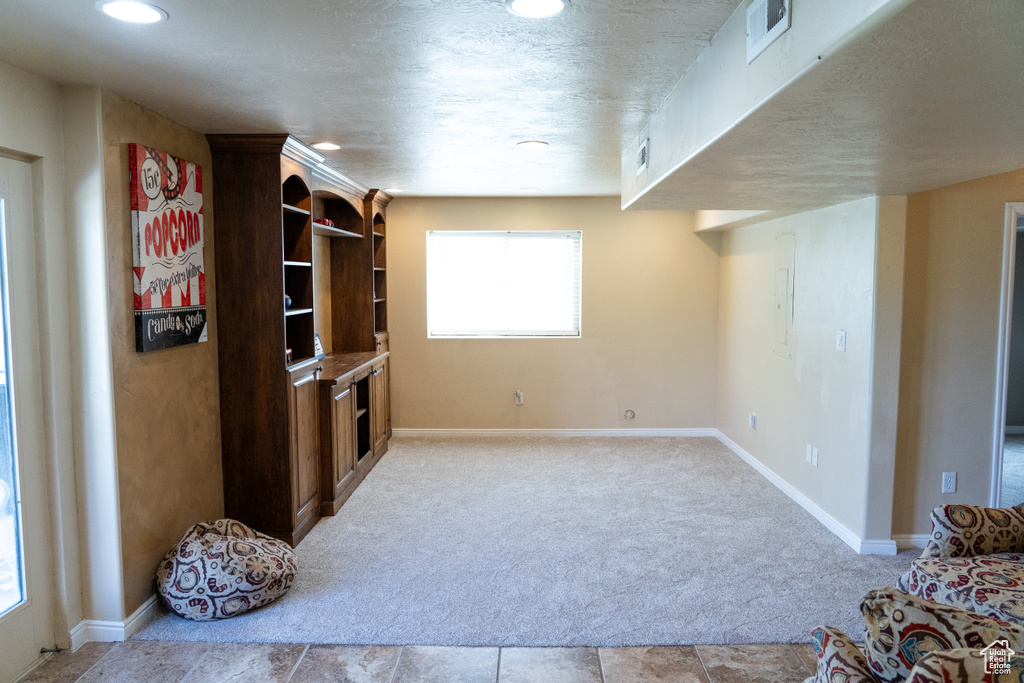 Unfurnished living room with carpet floors and recessed lighting
