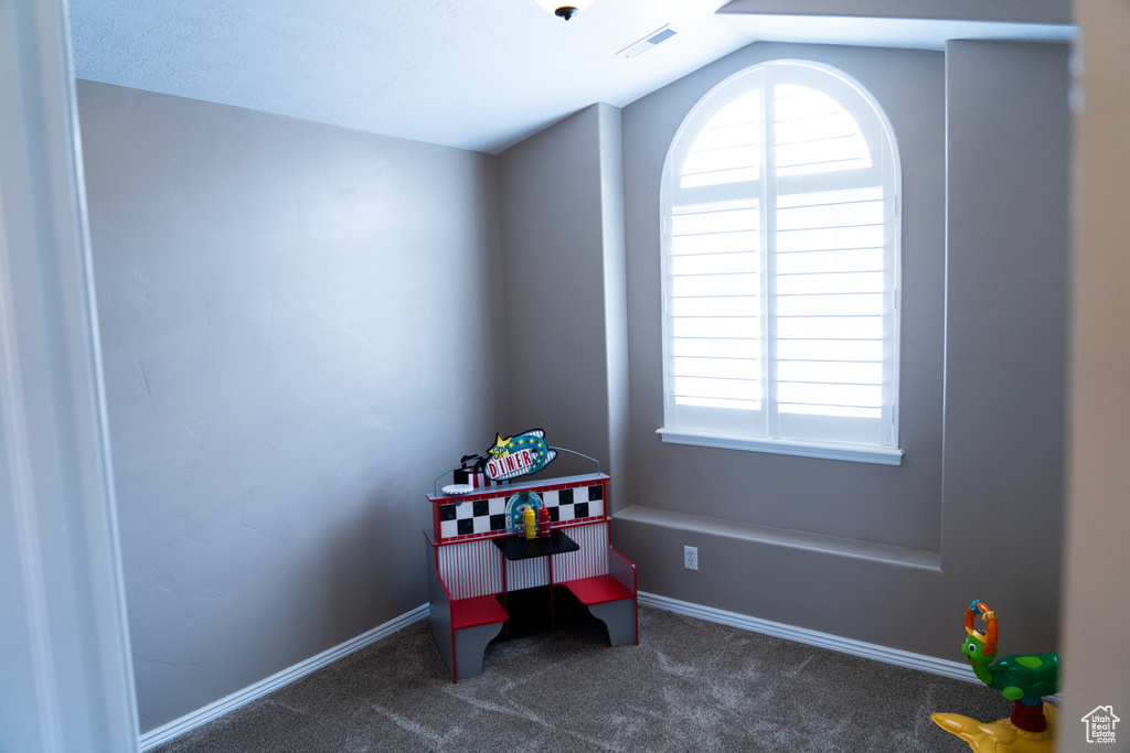 Game room featuring lofted ceiling and carpet floors