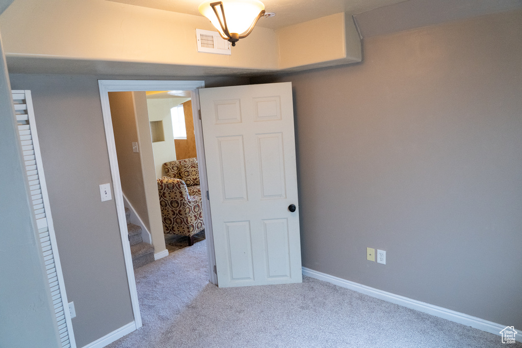 Carpeted empty room featuring baseboards