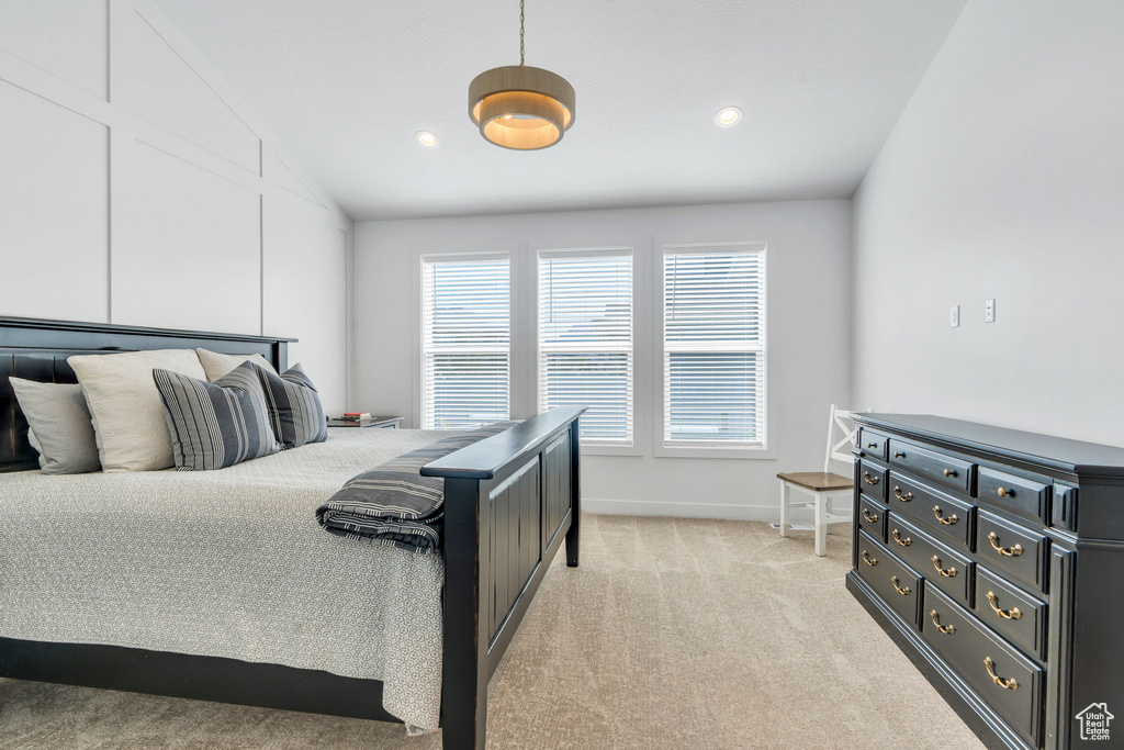 Bedroom featuring vaulted ceiling, light colored carpet, and recessed lighting