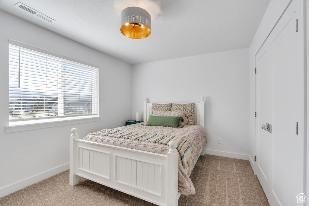 Carpeted bedroom featuring baseboards