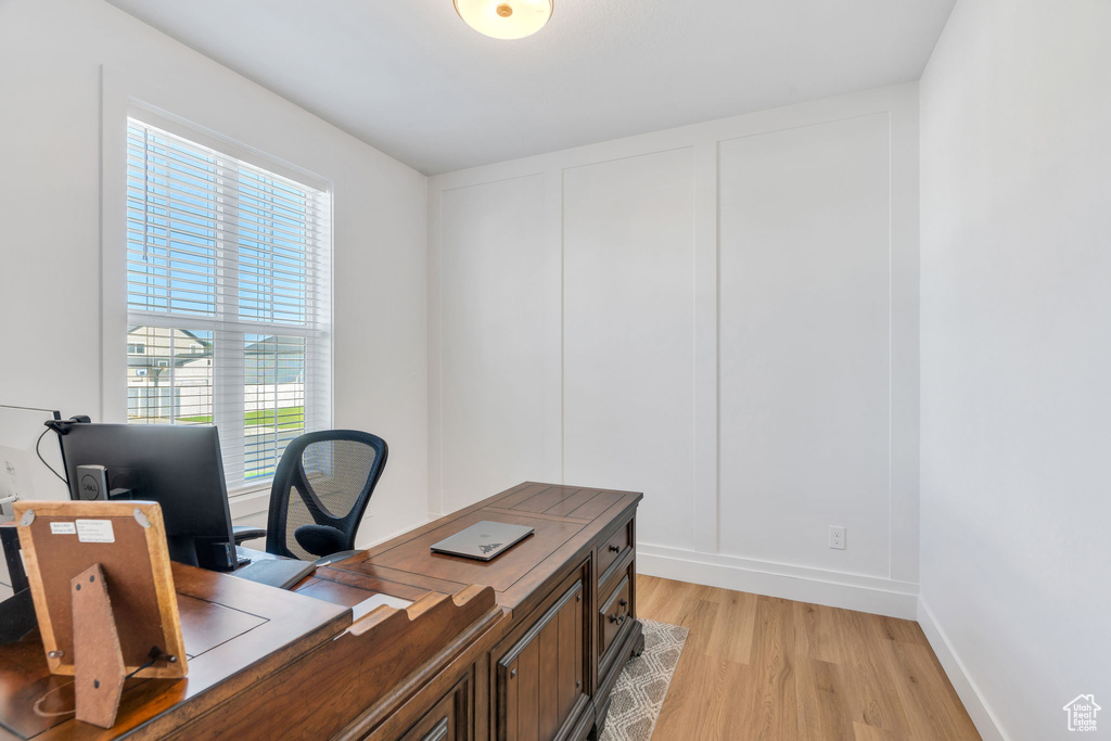 Office space with light wood finished floors and baseboards