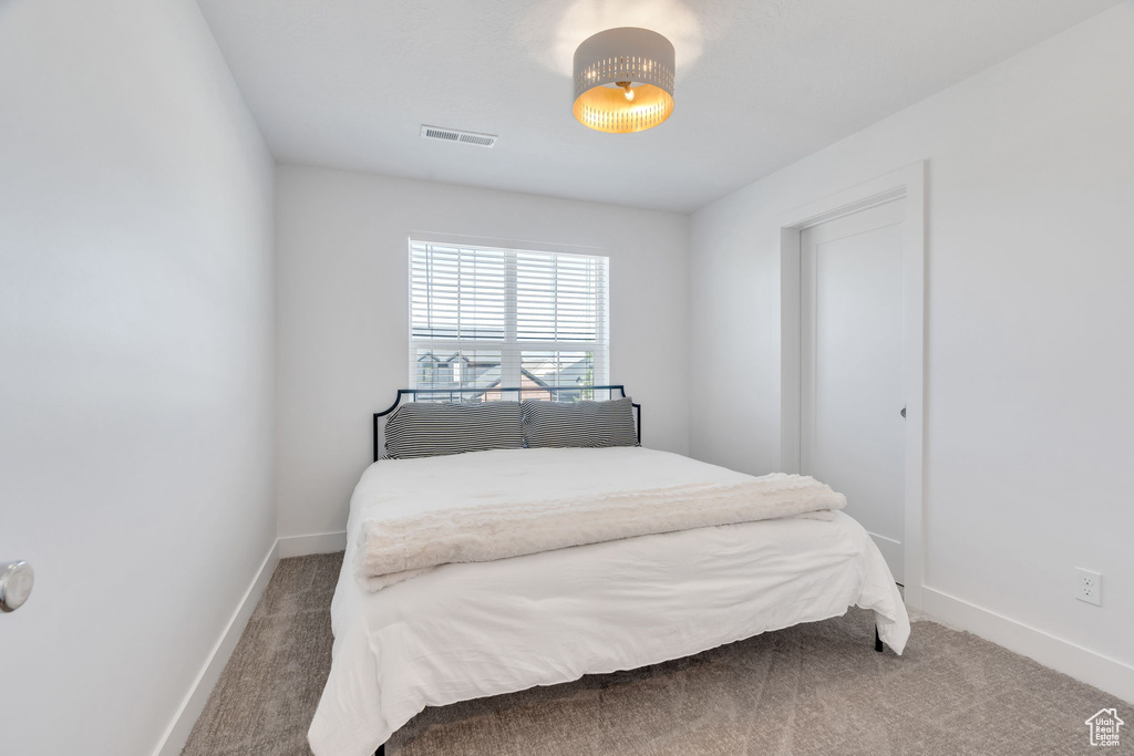 Carpeted bedroom with baseboards