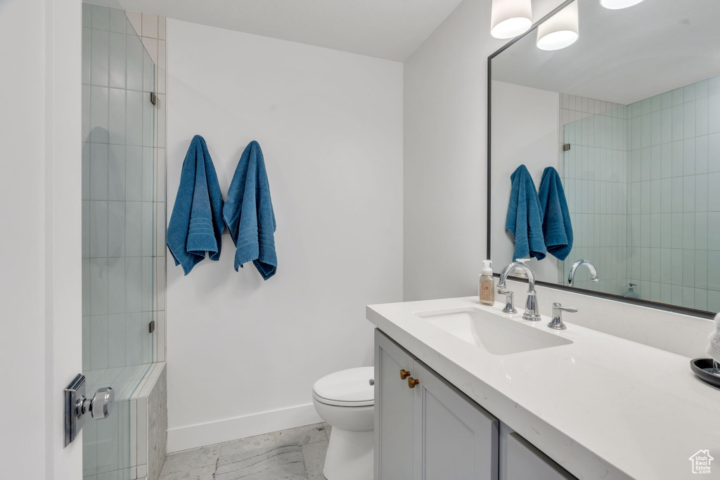 Full bathroom featuring vanity and a tile shower