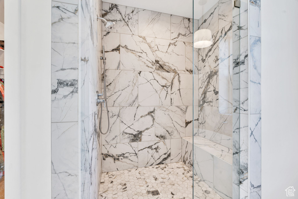 Bathroom featuring a marble finish shower