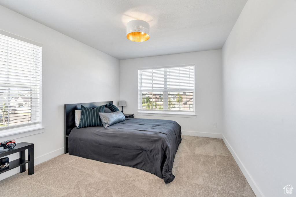 Bedroom featuring carpet floors and baseboards