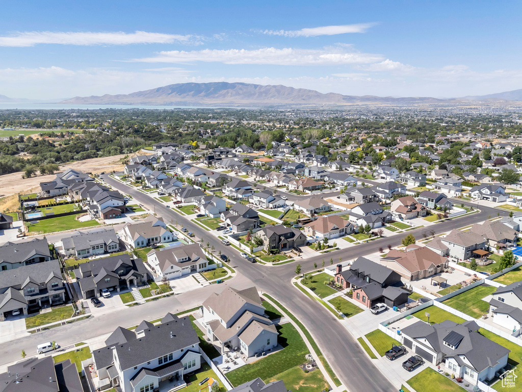 Aerial view of property and surrounding area with mountains and nearby suburban area