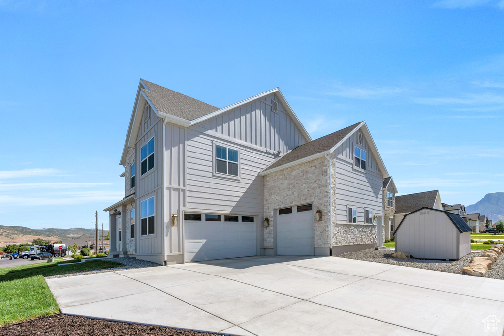 View of home\\\\\\\\\\\\\\\\\\\\\\\\\\\\\\\\\\\\\\\\\\\\\\\\\\\\\\\\\\\\\\\'s exterior featuring board and batten siding, a mountain view, a garage, concrete driveway, and stone siding