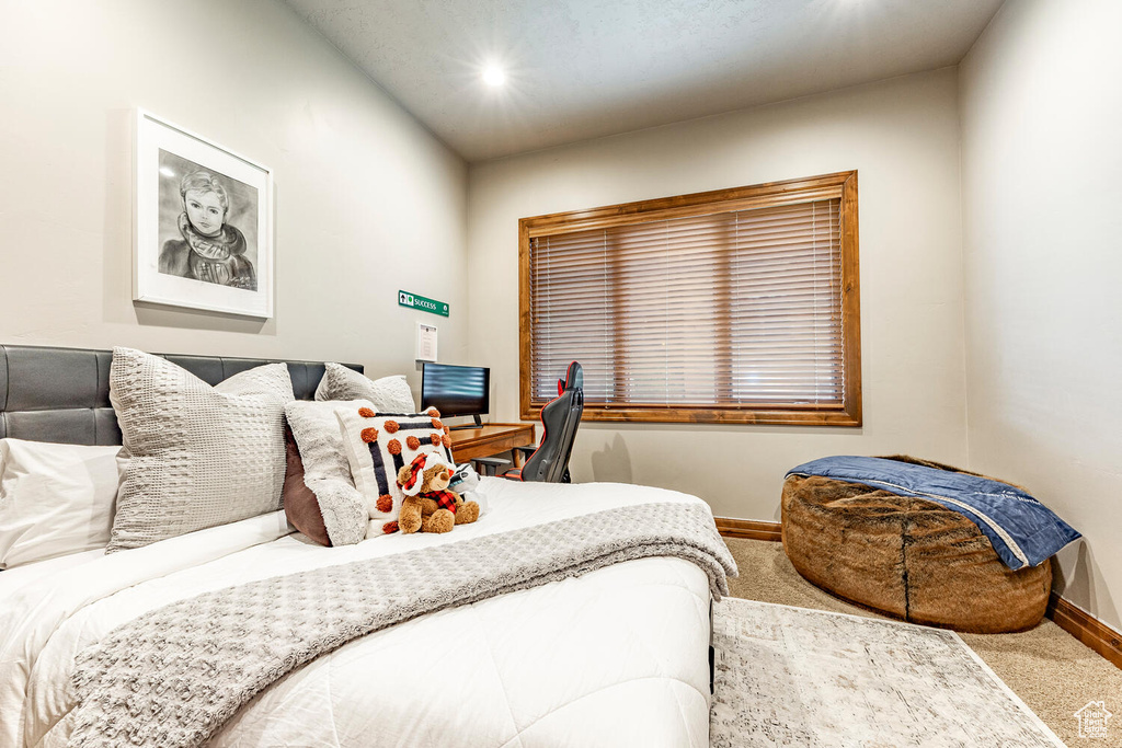 Carpeted bedroom with baseboards