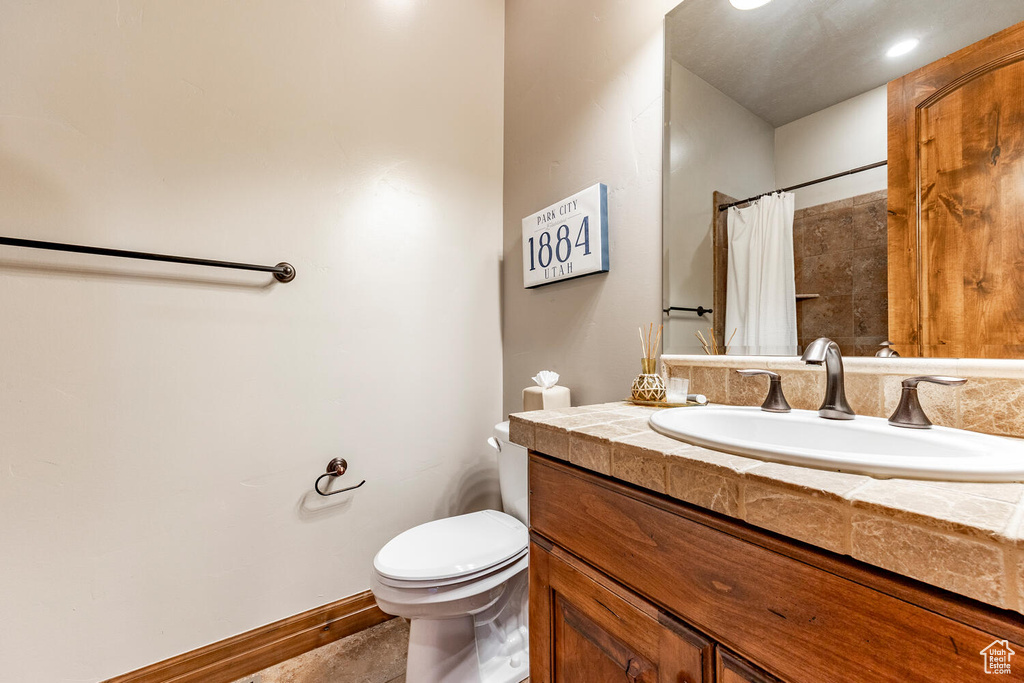 Full bath with vanity and a shower with curtain