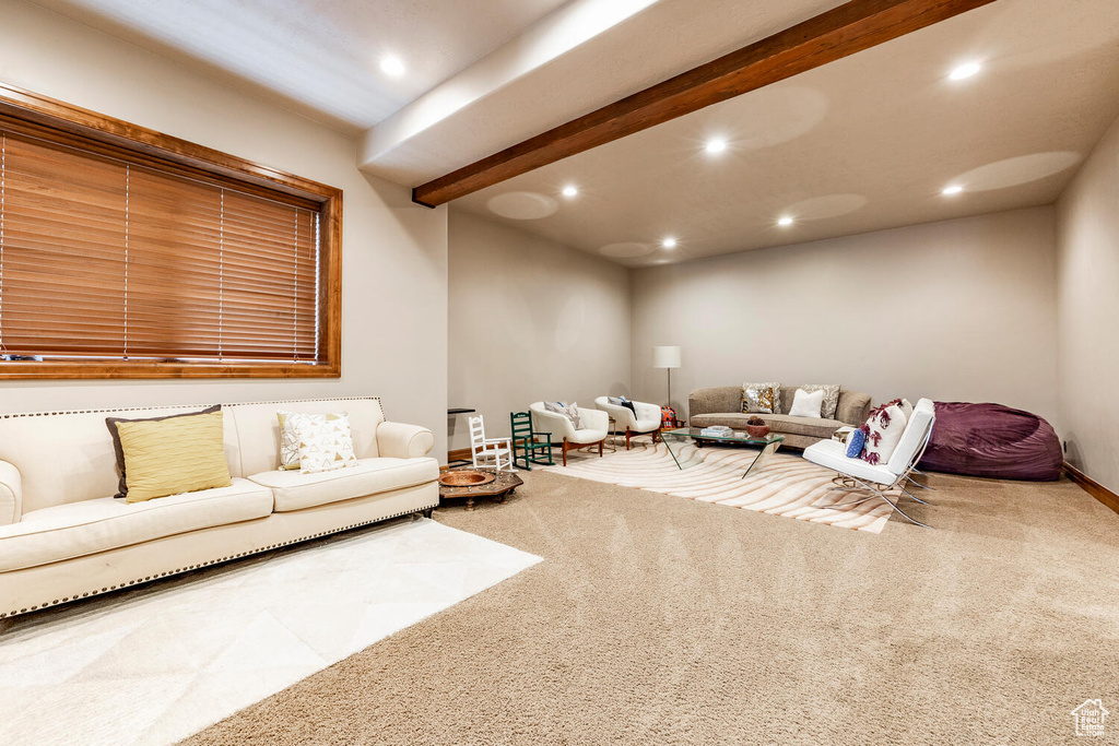 Carpeted living area featuring recessed lighting and beam ceiling