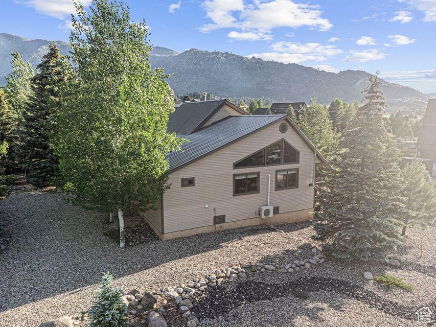 View of side of home with a mountain view