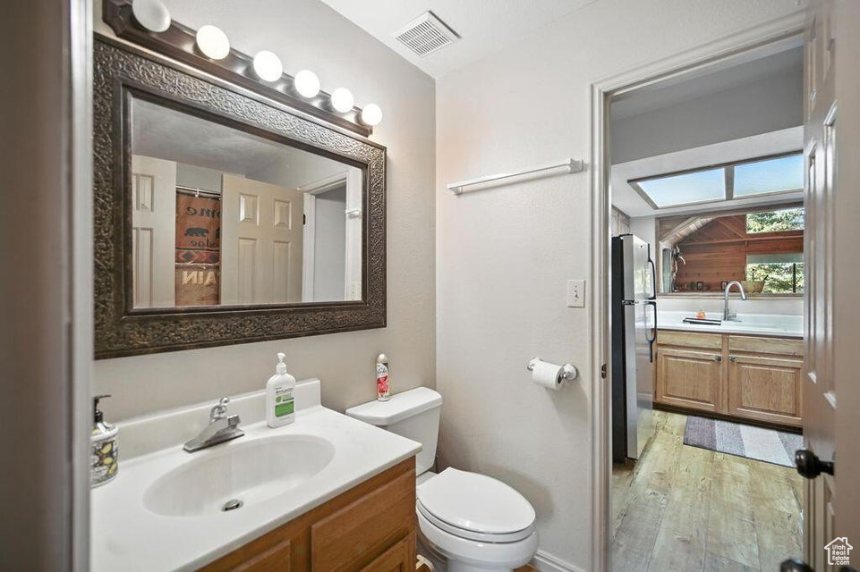 Full bathroom featuring vanity and wood finished floors