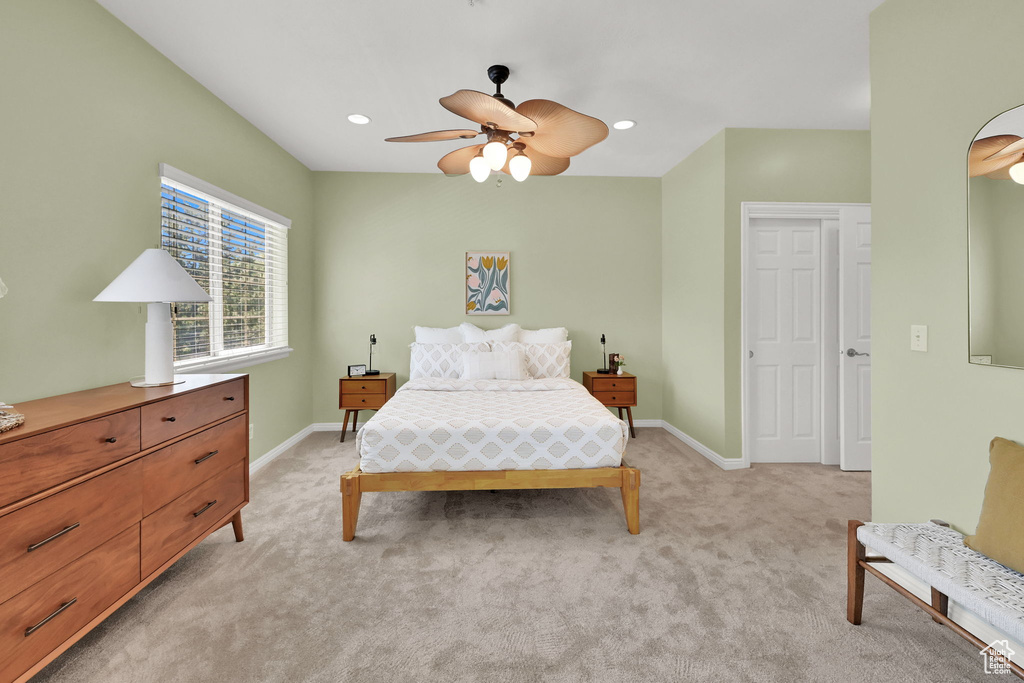 Bedroom featuring light carpet, ceiling fan, and recessed lighting