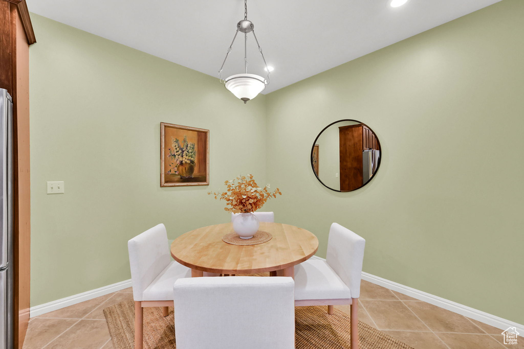 Dining area featuring light tile patterned floors and recessed lighting