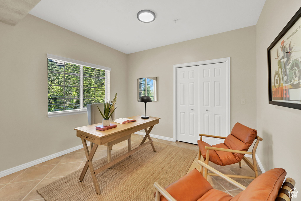 Office with light tile patterned floors and baseboards