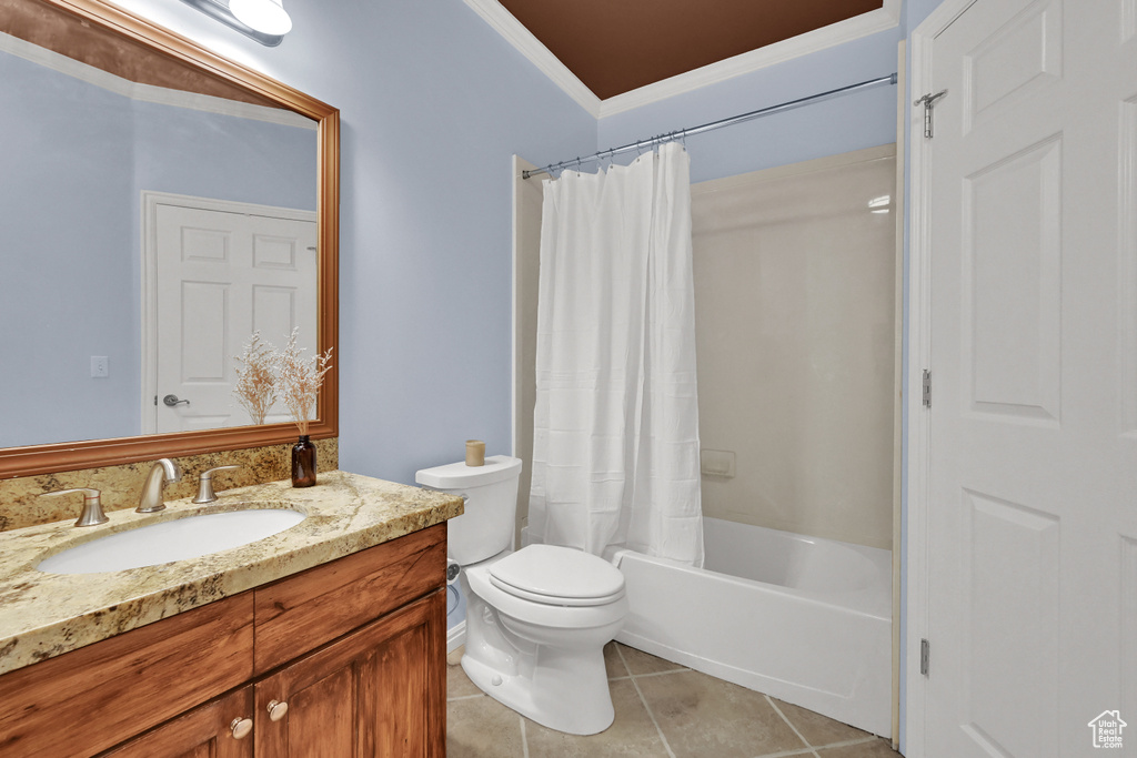 Bathroom featuring vanity, tile patterned flooring, shower / bath combo with shower curtain, and crown molding