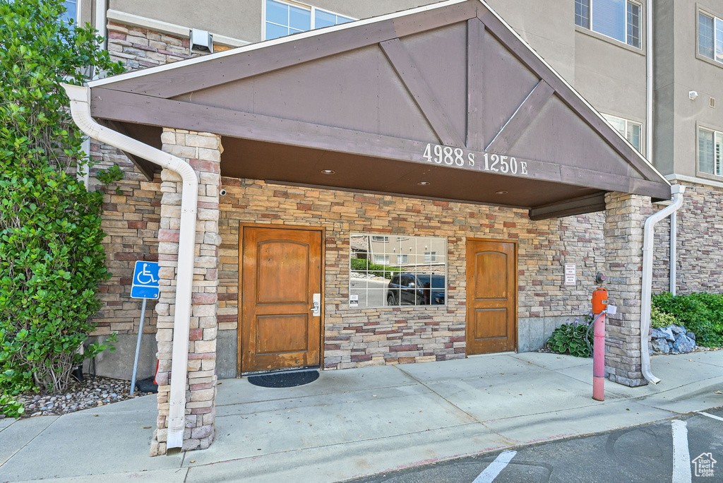 Entrance to property with stone siding