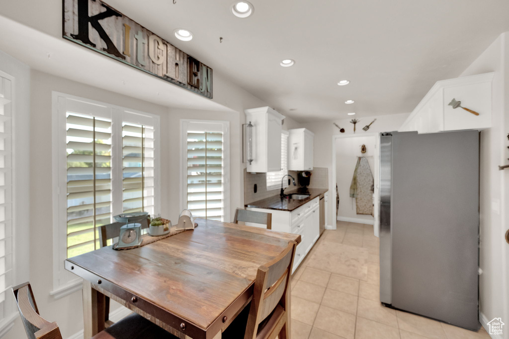 Dining space featuring recessed lighting and light tile patterned floors