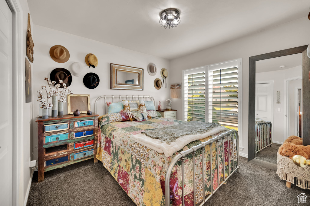 Bedroom featuring dark carpet