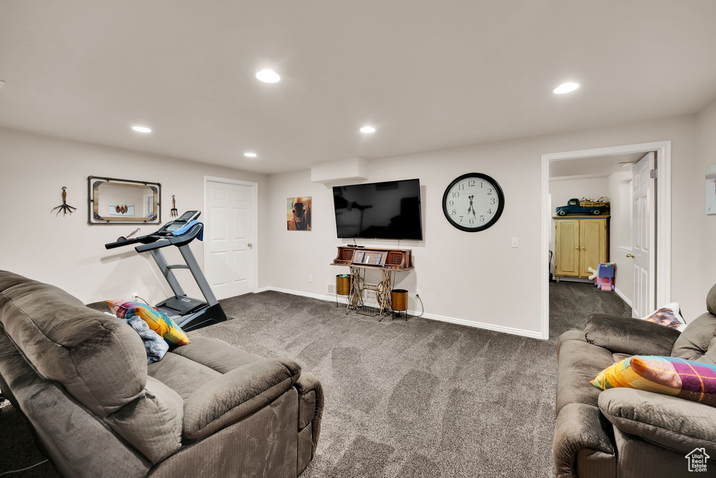 Living area featuring dark carpet and recessed lighting