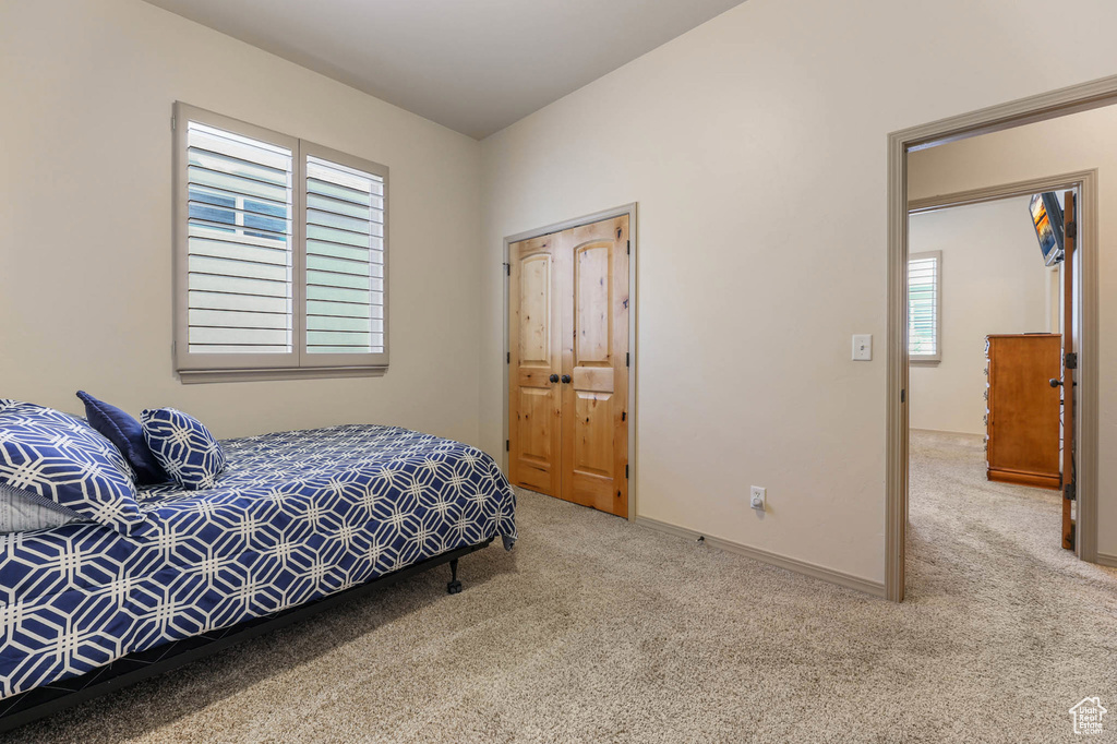 Carpeted bedroom with baseboards
