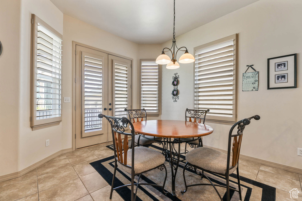 Dining space with light tile patterned floors and baseboards