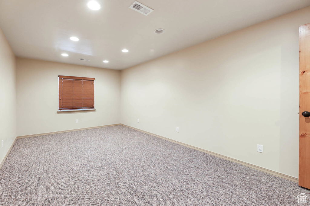 Spare room featuring recessed lighting and carpet flooring