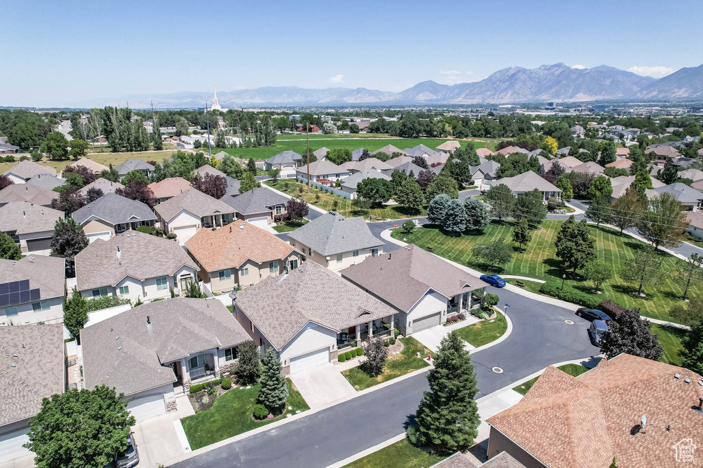 Aerial perspective of suburban area featuring a mountain backdrop