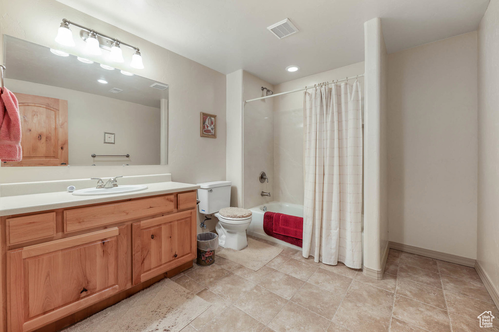 Bathroom featuring vanity and shower / tub combo with curtain