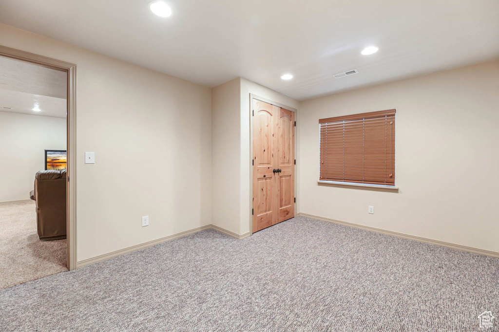 Unfurnished bedroom with carpet and recessed lighting