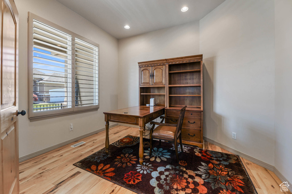 Home office featuring light wood-style flooring and recessed lighting