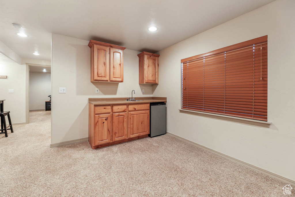 Kitchen featuring dishwashing machine, light colored carpet, recessed lighting, and light countertops
