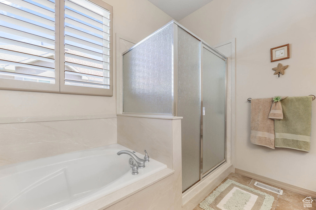 Full bathroom with a shower stall and a garden tub