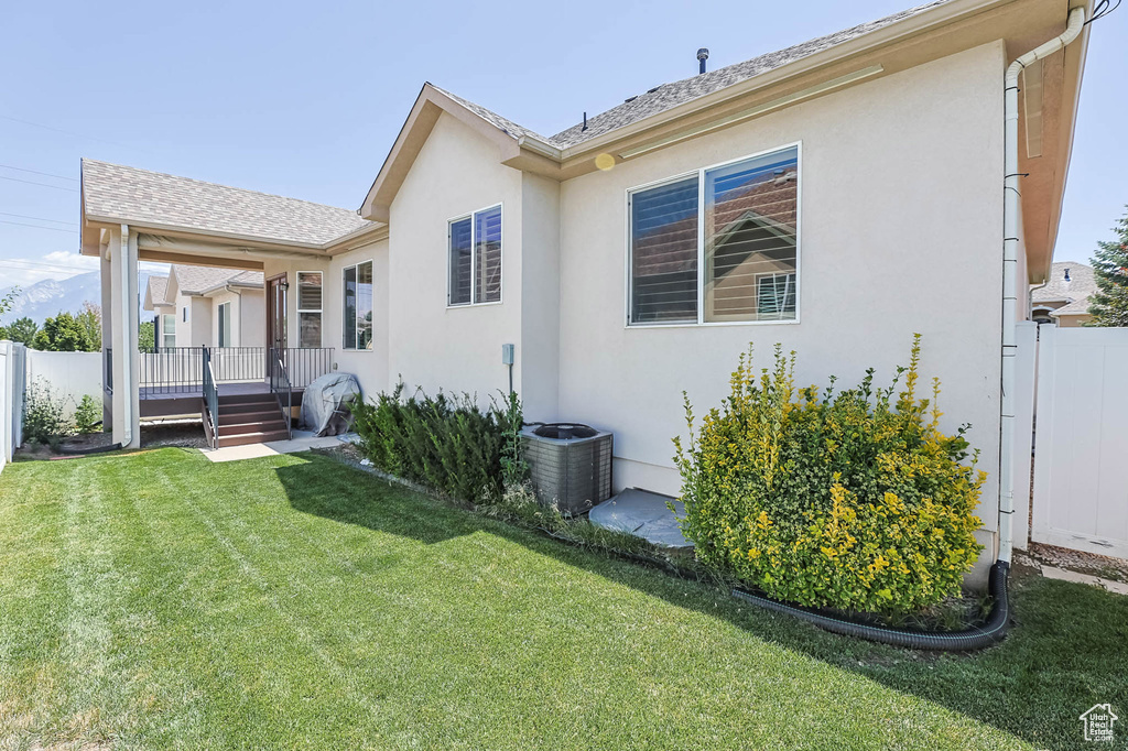Rear view of property with stucco siding