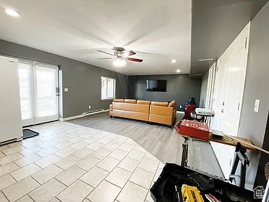 Living room featuring ceiling fan, recessed lighting, and light tile patterned flooring
