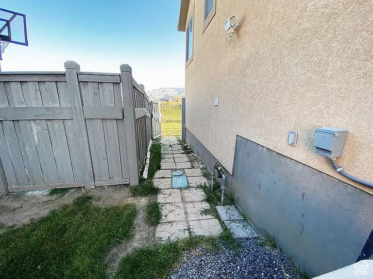 View of side of home with stucco siding
