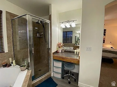 Full bath featuring a stall shower and a whirlpool tub