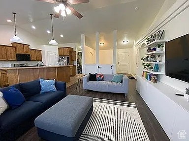 Living area with dark wood finished floors, a ceiling fan, and recessed lighting
