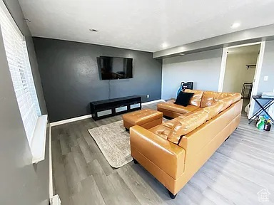 Living room with wood finished floors and recessed lighting