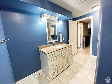 Bathroom with vanity and tile patterned floors