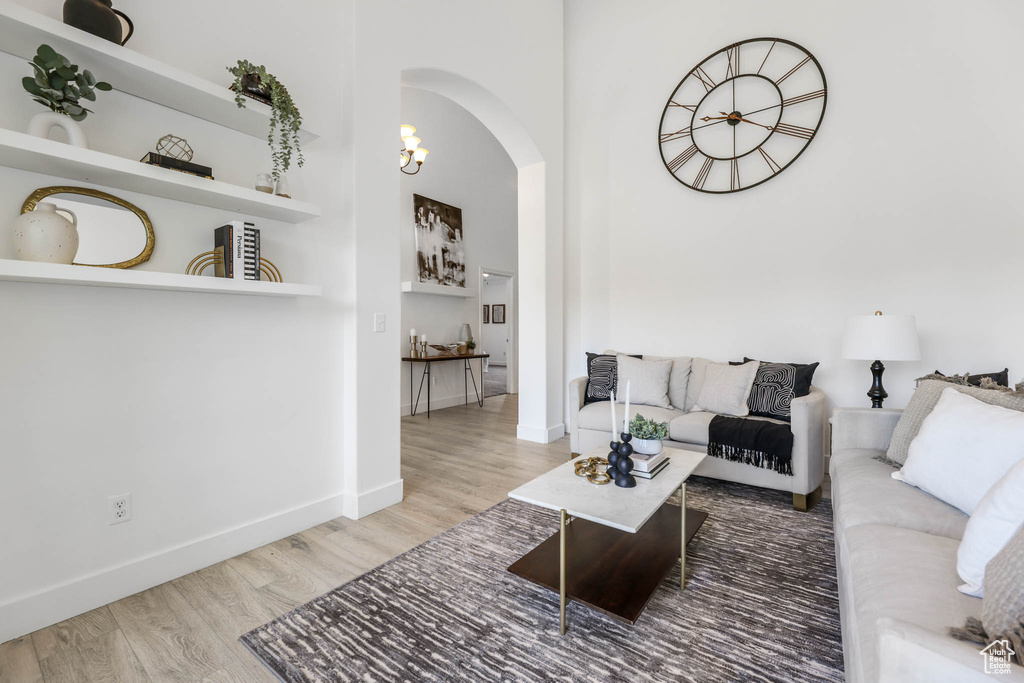 Living room featuring arched walkways and wood finished floors