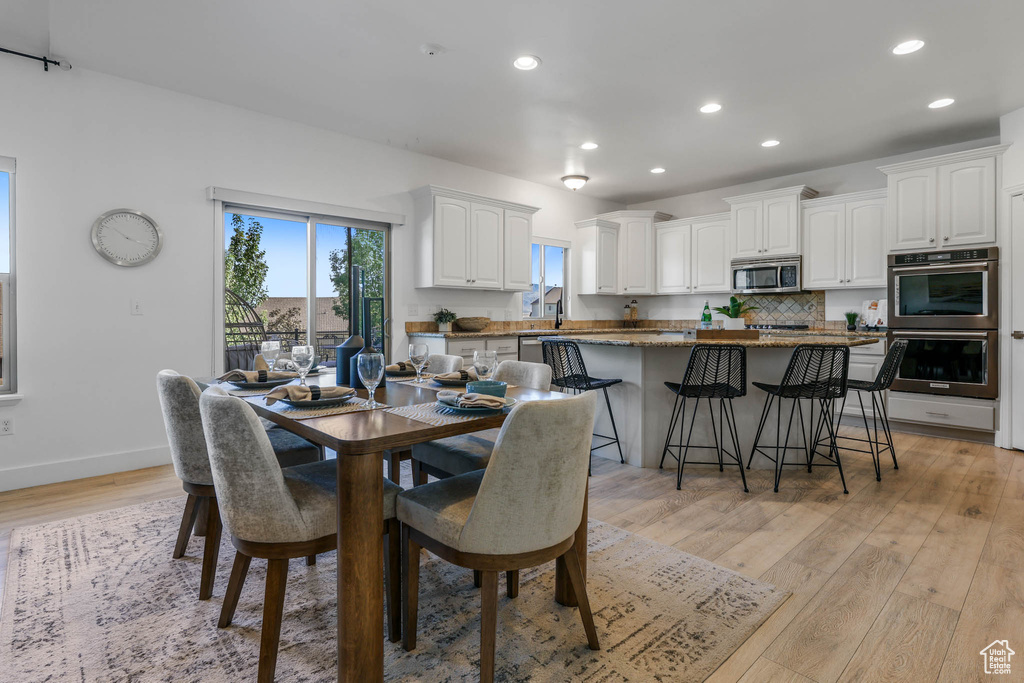 Dining room featuring light wood-type flooring and recessed lighting